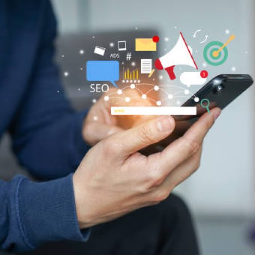 close up young man hand hold smartphone and use application of e-commerce to working about social media marketing tools for business and technology concept